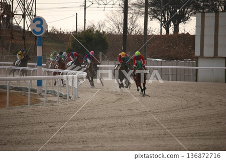 Horse and rider galloping through the fourth corner at Kasamatsu Racecourse Horse and rider galloping through the fourth corner at Kasamatsu Racecourse 136872716