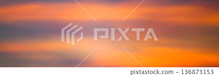 Mysterious clouds and a sky with an orange gradient Mysterious clouds and a sky with an orange gradient 136873153