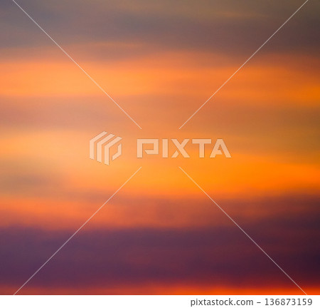 Mysterious clouds and a sky with an orange gradient Mysterious clouds and a sky with an orange gradient 136873159