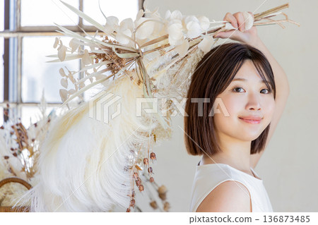 One-piece woman holding a bouquet of dried flowers One-piece woman holding a bouquet of dried flowers 136873485