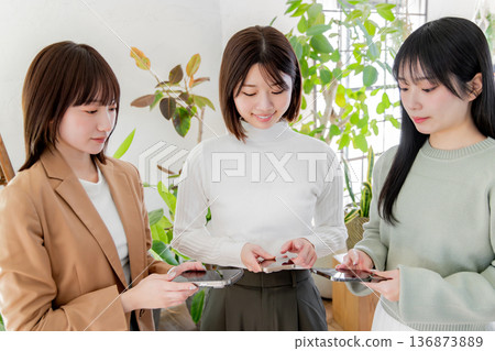 Three women using smartphones Three women using smartphones 136873889