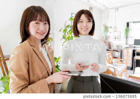 兩名婦女使用智慧型手機 兩名婦女使用智慧型手機 136873895