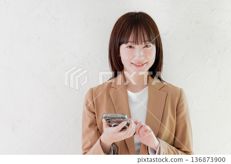 Business woman searching on smartphone Business woman searching on smartphone 136873900