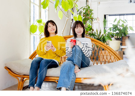 Woman friends relaxing in the room 136874074