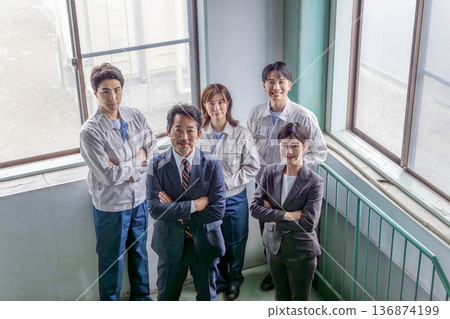 A group of company employees lined up indoors A group of company employees lined up indoors 136874199