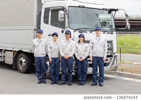A group of workers lined up in front of a truck A group of workers lined up in front of a truck 136874243