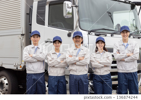 A group of workers lined up in front of a truck A group of workers lined up in front of a truck 136874244