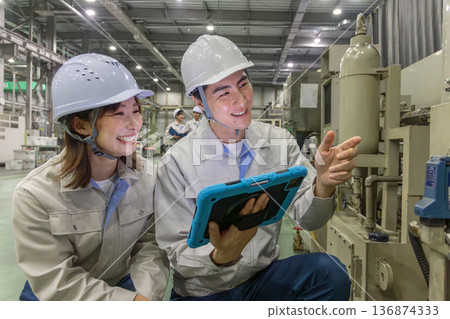 Group of workers working in a factory Group of workers working in a factory 136874333