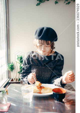 A Japanese woman in her 30s eating omurice, lunch scene A Japanese woman in her 30s eating omurice, lunch scene 136874929
