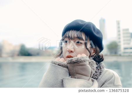 A Japanese woman in her 30s looking up at the sky along a river in winter A Japanese woman in her 30s looking up at the sky along a river in winter 136875328
