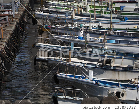 Fishing boats anchored at the fishing port Fishing boats anchored at the fishing port 136875358