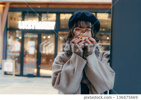 A Japanese woman in her 30s enjoying sweets in a winter town A Japanese woman in her 30s enjoying sweets in a winter town 136875669