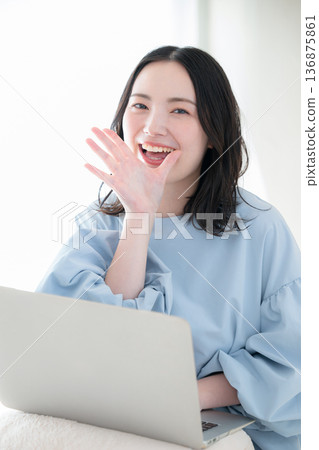 Smiling woman calling for applications on a computer, support, etc., online service usage image Smiling woman calling for applications on a computer, support, etc., online service usage image 136875861