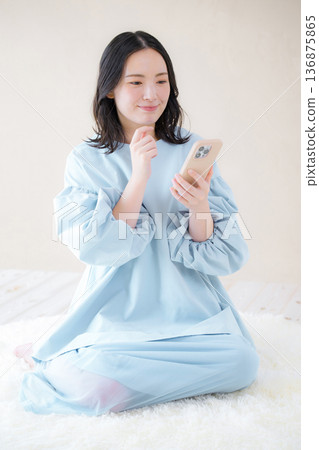 A smiling woman using a smartphone. Image of online use, reviews, and applications for services. 136875865