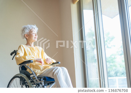 Senior woman relaxing in a wheelchair 136876708