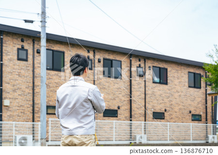 Male worker looking at the building Male worker looking at the building 136876710