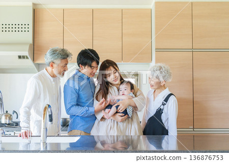 Smiling three-generation family surrounding a baby Smiling three-generation family surrounding a baby 136876753