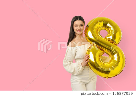 Woman marks Women's Day with a number 8 balloon Woman marks Women's Day with a number 8 balloon 136877039