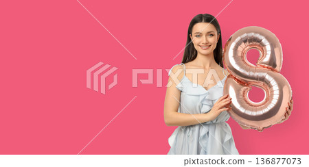 Young woman smiles with an 8-shaped balloon 136877073