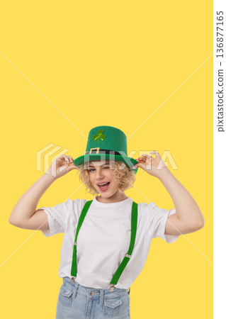 Woman wearing a green hat and smiling for St Patrick's Day 136877165