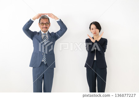 Businessman posing with circle and cross Businessman posing with circle and cross 136877227