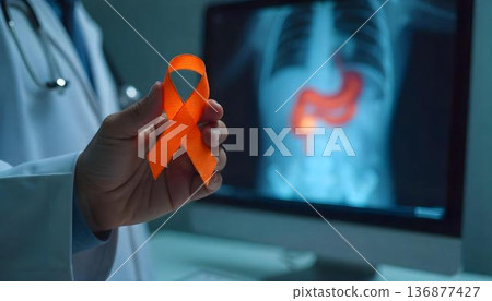 In a medical setting, a doctor presents an orange ribbon, highlighting Leukemia Awareness Month and the fight against blood cancer 136877427