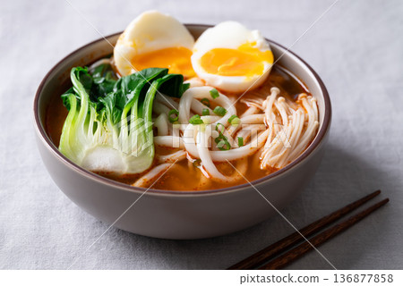 Spicy Udon Noodle Soup topped with Bok Choy, Enoki Mushrooms and Soft Boiled Egg Spicy Udon Noodle Soup topped with Bok Choy, Enoki Mushrooms and Soft Boiled Egg 136877858