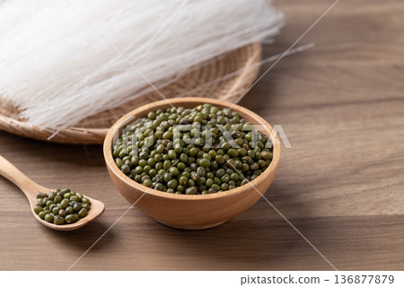 Mung beans seeds and dried glass noodles on a wooden table, raw ingredients for Thai vermicelli 136877879