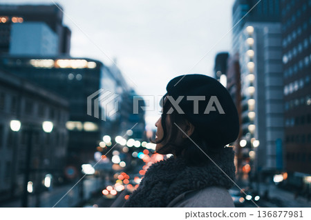 A Japanese woman in her 30s lost in thought in the city at night A Japanese woman in her 30s lost in thought in the city at night 136877981