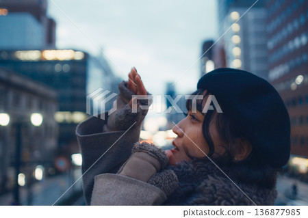 A Japanese woman in her 30s lost in thought in the city at night A Japanese woman in her 30s lost in thought in the city at night 136877985