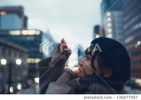 A Japanese woman in her 30s lost in thought in the city at night A Japanese woman in her 30s lost in thought in the city at night 136877987