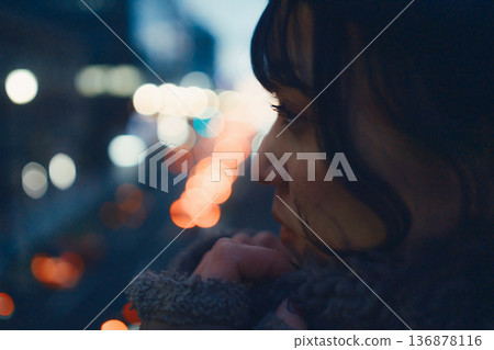 Profile of a Japanese woman in her 30s gazing at the city at night Profile of a Japanese woman in her 30s gazing at the city at night 136878116