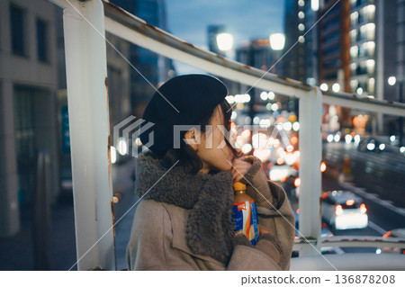 A Japanese woman in her 30s looking to the future in the city at night A Japanese woman in her 30s looking to the future in the city at night 136878208