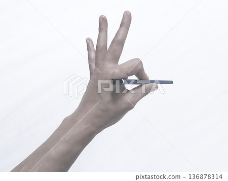 Hand holding a pencil Hand holding a pencil 136878314