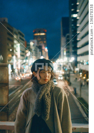 A Japanese woman in her 30s standing in the city at night 136878338