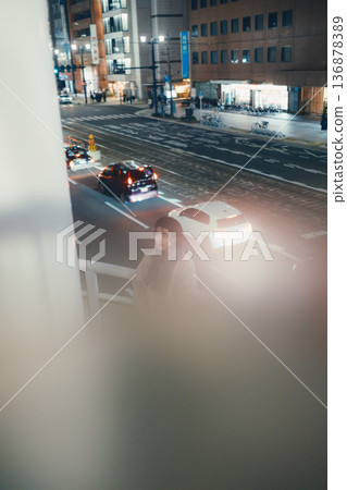A Japanese woman standing on a pedestrian bridge at night A Japanese woman standing on a pedestrian bridge at night 136878389