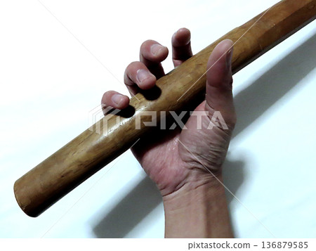 Hand holding a sword 136879585