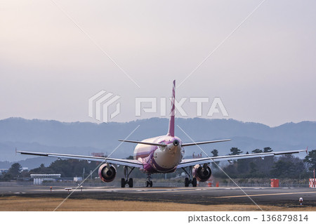 Sendai Airport at dusk, airplane taking off, Natori City, Miyagi Prefecture Sendai Airport at dusk, airplane taking off, Natori City, Miyagi Prefecture 136879814