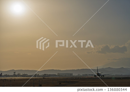 Sendai Airport at dusk, airplane taking off, Natori City, Miyagi Prefecture Sendai Airport at dusk, airplane taking off, Natori City, Miyagi Prefecture 136880344