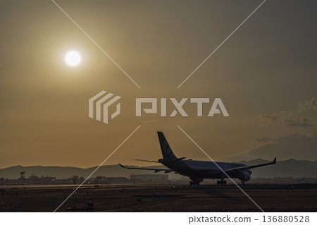 Sendai Airport at dusk: Sunset and taxiing planes, Natori City, Miyagi Prefecture Sendai Airport at dusk: Sunset and taxiing planes, Natori City, Miyagi Prefecture 136880528