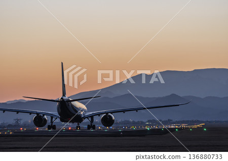 Sendai Airport at dusk: Sunset and planes taking off, Natori City, Miyagi Prefecture Sendai Airport at dusk: Sunset and planes taking off, Natori City, Miyagi Prefecture 136880733