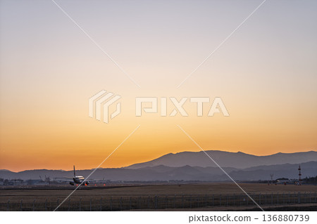 Sendai Airport at dusk: Sunset and planes taking off, Natori City, Miyagi Prefecture Sendai Airport at dusk: Sunset and planes taking off, Natori City, Miyagi Prefecture 136880739
