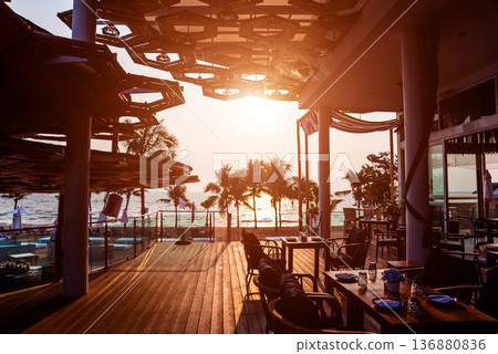 Beautiful tropical beach restaurant with palm trees. Beautiful tropical beach restaurant with palm trees. 136880836