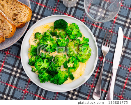 Omelette with broccoli served on plate 136881775