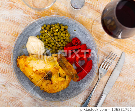 Fried chicken served with peas and peppers Fried chicken served with peas and peppers 136881795