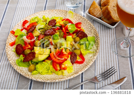 Salad with chorizo, avocado, pepper, olives and pesto Salad with chorizo, avocado, pepper, olives and pesto 136881818