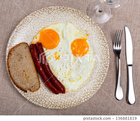 Fried eggs served with chistorra sausages Fried eggs served with chistorra sausages 136881819