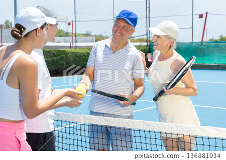 Portrait of smiling tennis team. Portrait of smiling tennis team. 136881934