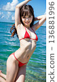 Smiling young woman in bikini swimsuit on summer beach 136881996