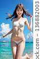 Smiling young woman in bikini swimsuit on summer beach 136882003
